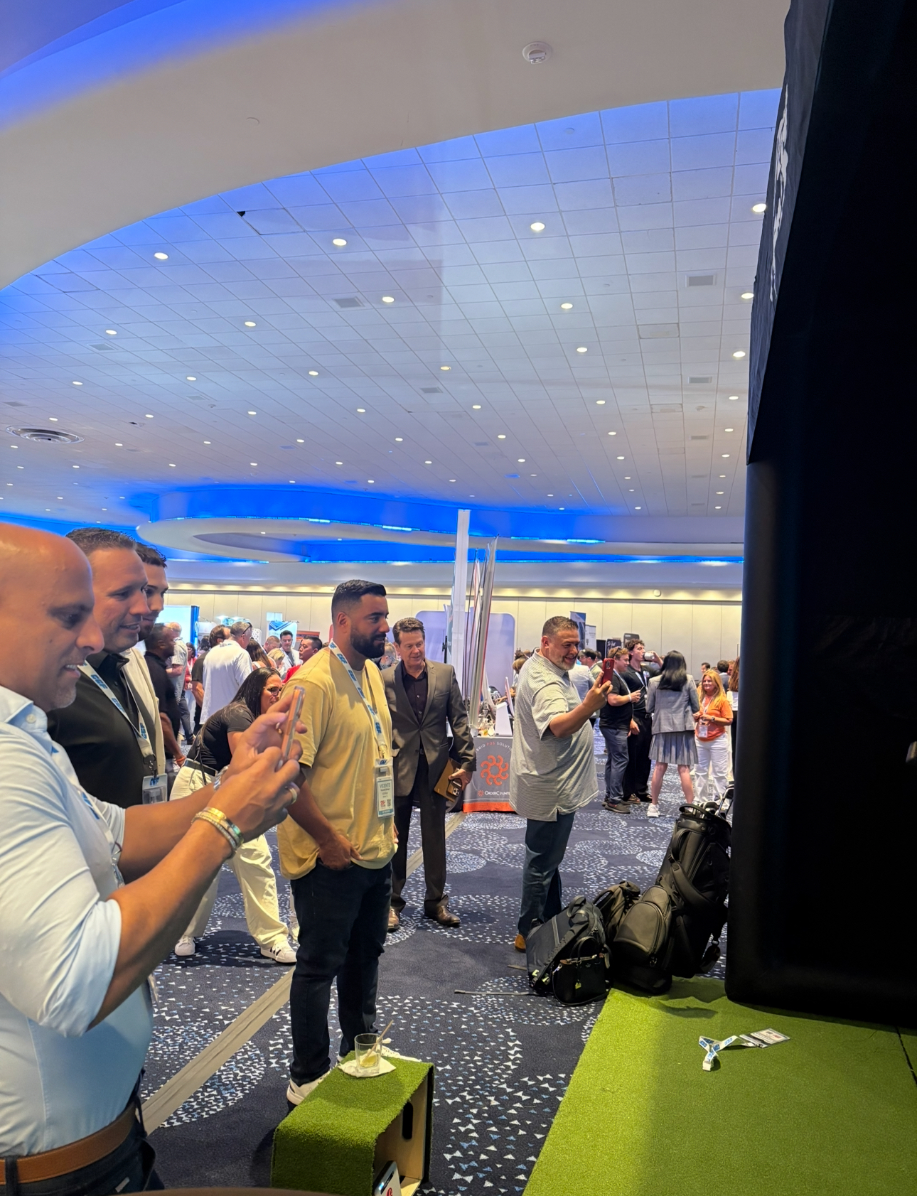 Attendees taking swings during a conference activation with PopGolf